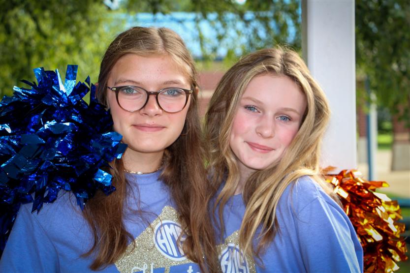 Two students smile